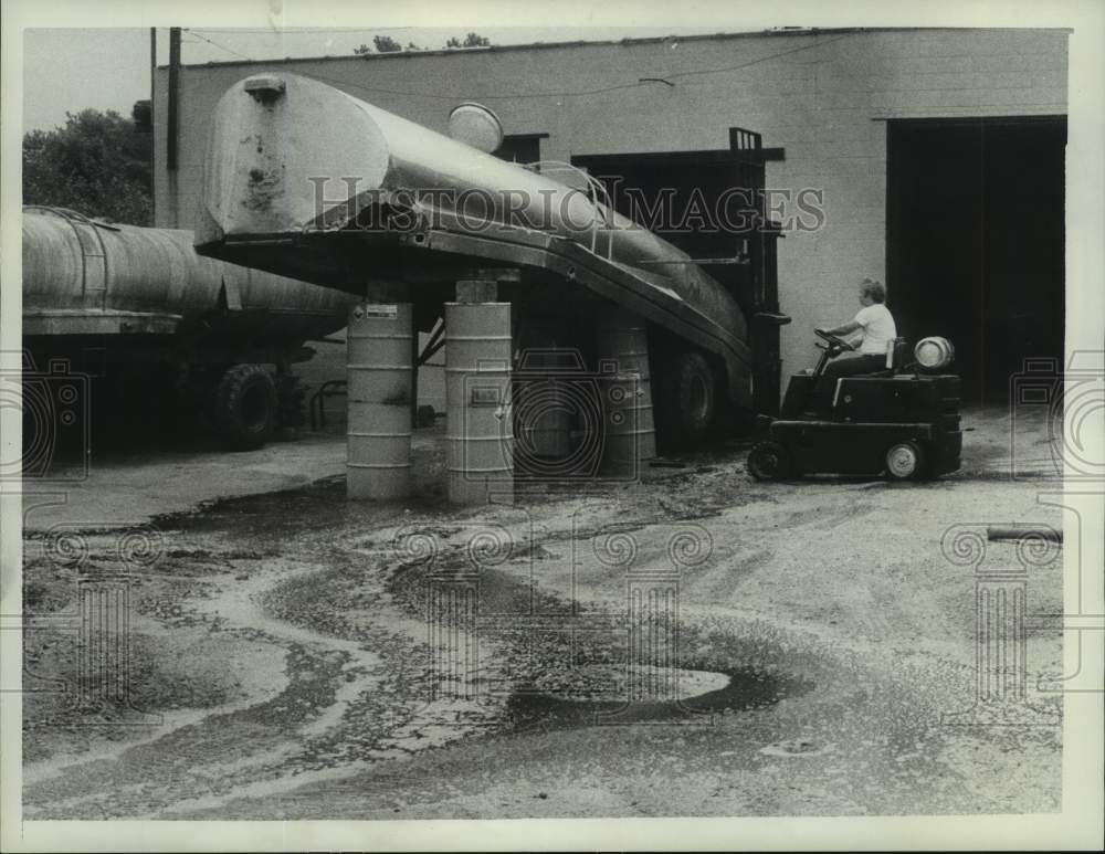 1977 Worker moves leaking chemical storage tanker in Albany, NY - Historic Images