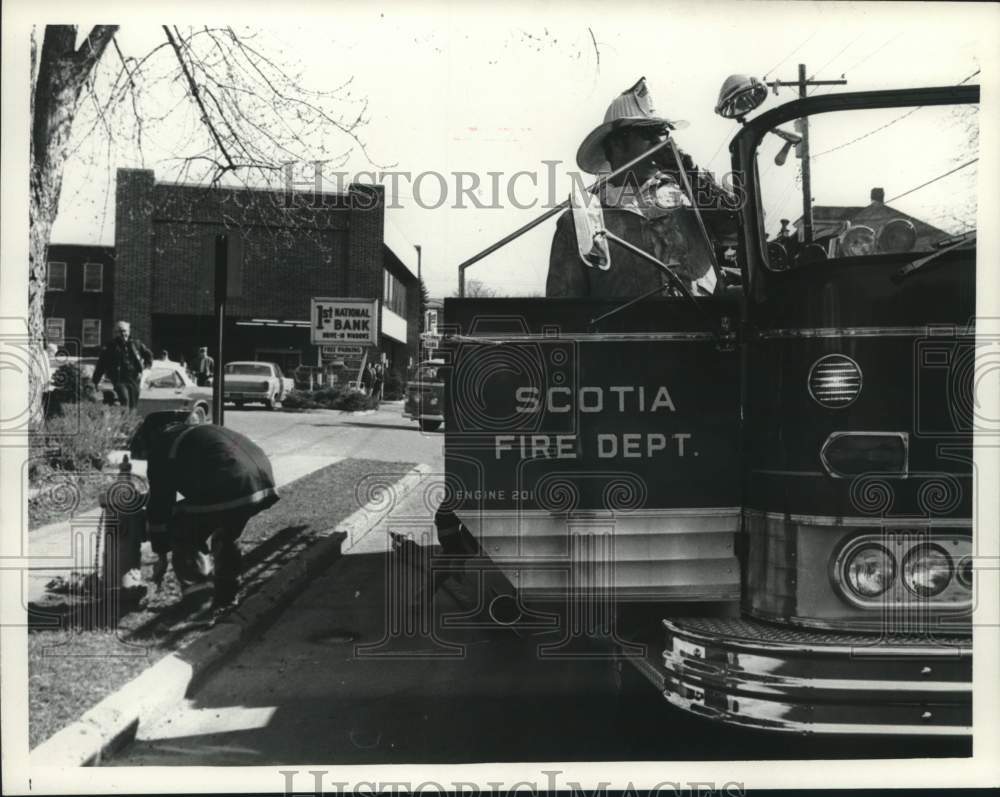 1974 Scotia, New York Fire Department inspects fire hydrant - Historic Images