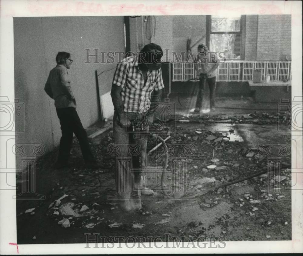 1980 Press Photo Crew tearing up floor of Scotia, New York Fire Department - Historic Images