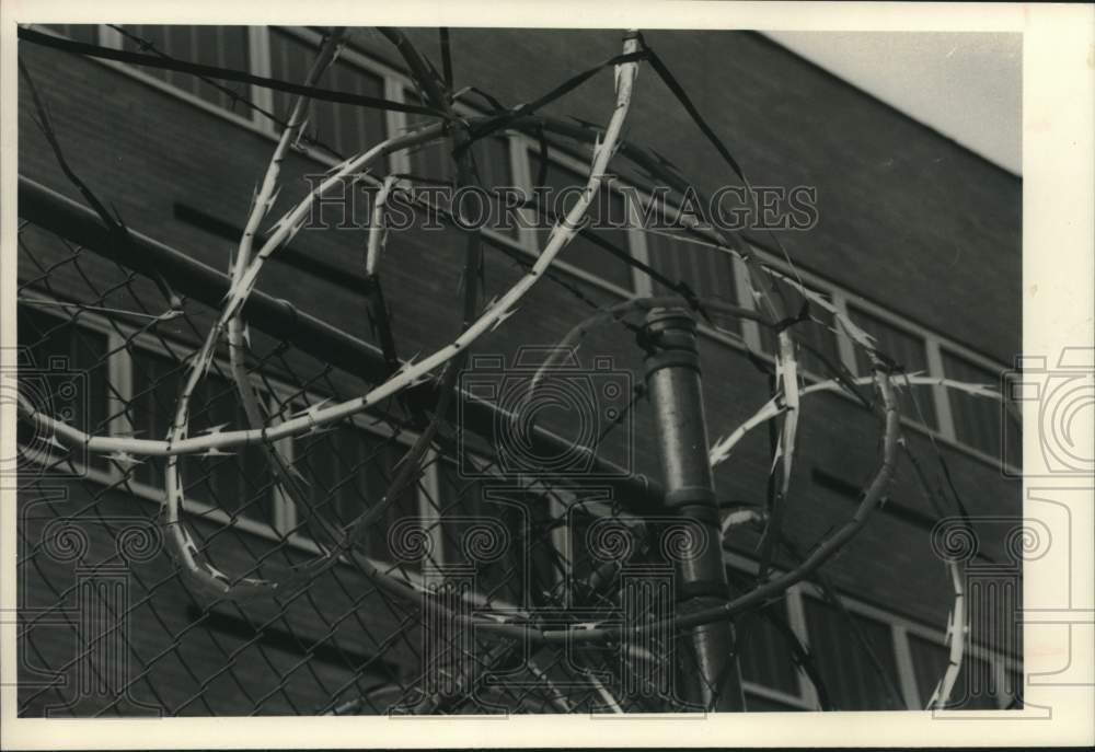 1984 Barb wire fence surrounds Schenectady County Jail in New York - Historic Images
