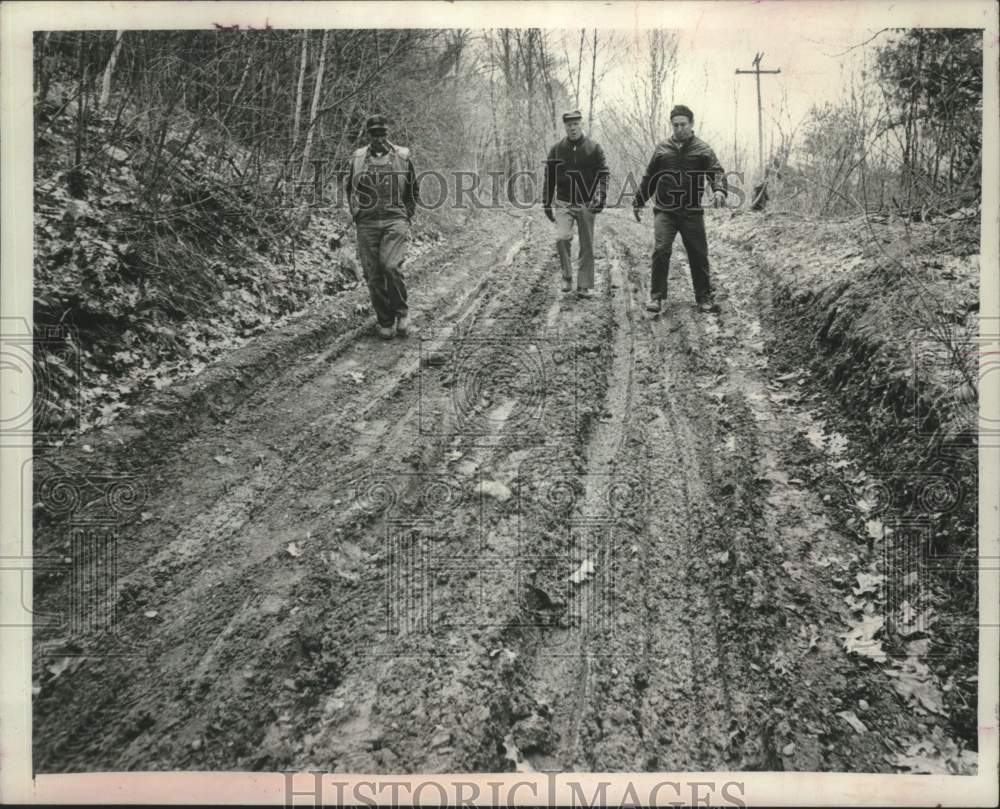 1975 Highway Department workers from Nassau, NY walk down dirt road - Historic Images