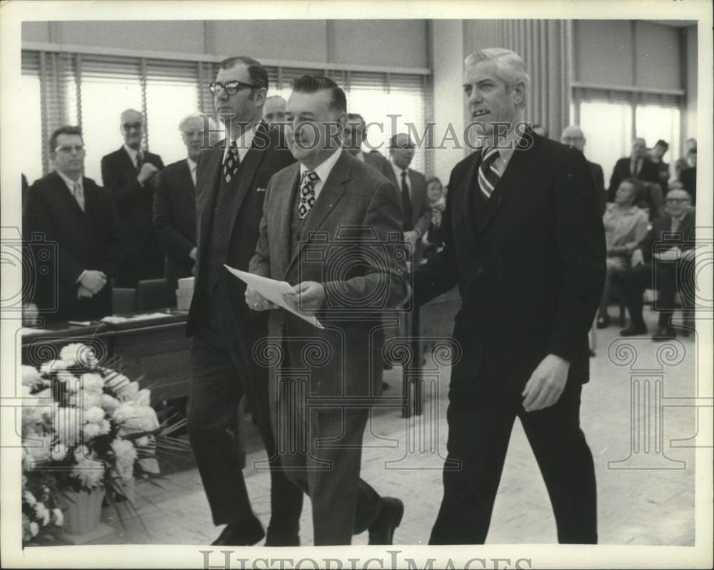 Press Photo John Daley, Fritz and McGuire walk during board meeting - tua16764 - Historic Images