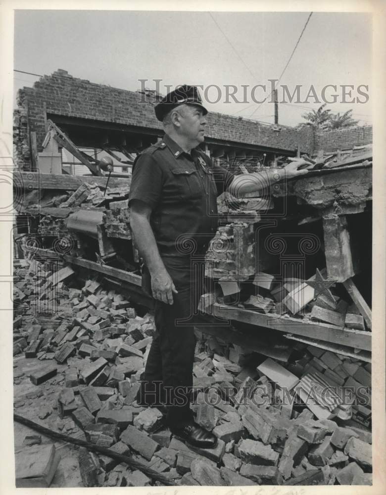 1971 Watervliet, New York police officer inspects collapsed building - Historic Images