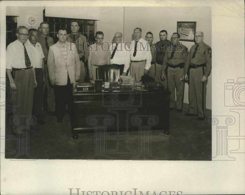 1955 Joseph W. Sayers poses with others behind desk - Historic Images