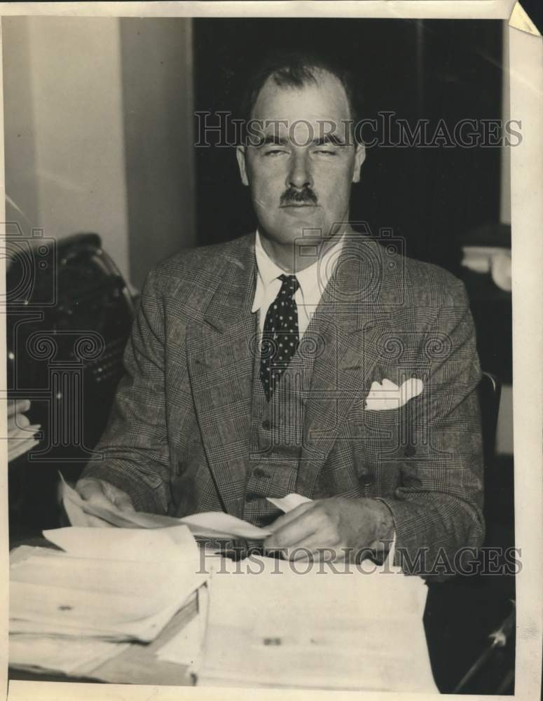1936 Press Photo  Lithgord Osborne poses for photo behind his desk - Historic Images