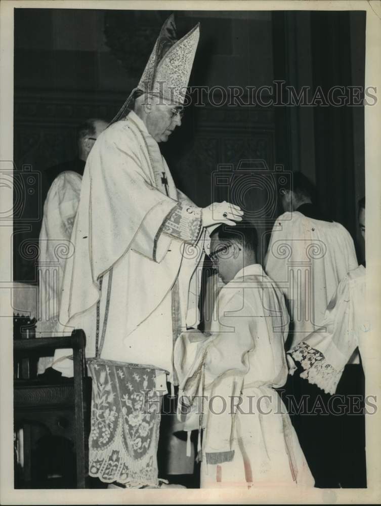 1963 Most Reverend William A Scully, puts hands on kneeling priest - Historic Images