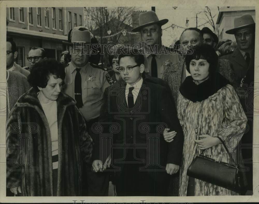 1967 Michael Liuni (2nd from right) walks with group of people - Historic Images