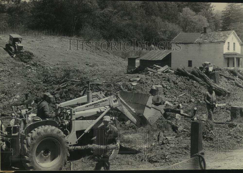 1970 Workers move downed trees to build swimming pool in Schoharie - Historic Images