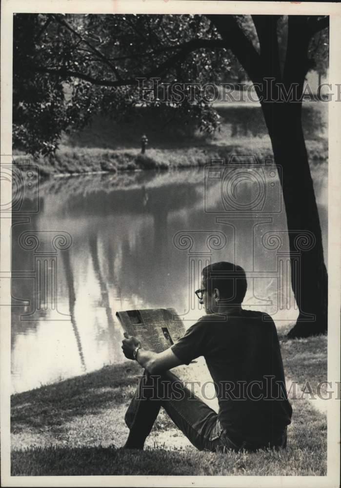 1972 Man reads newspaper in Washington Park, Albany, New York - Historic Images