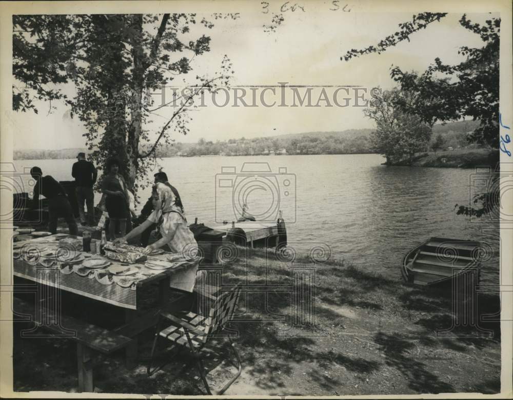 1963 Family enjoys a picnic on the shore of Nassau Lake, New York - Historic Images