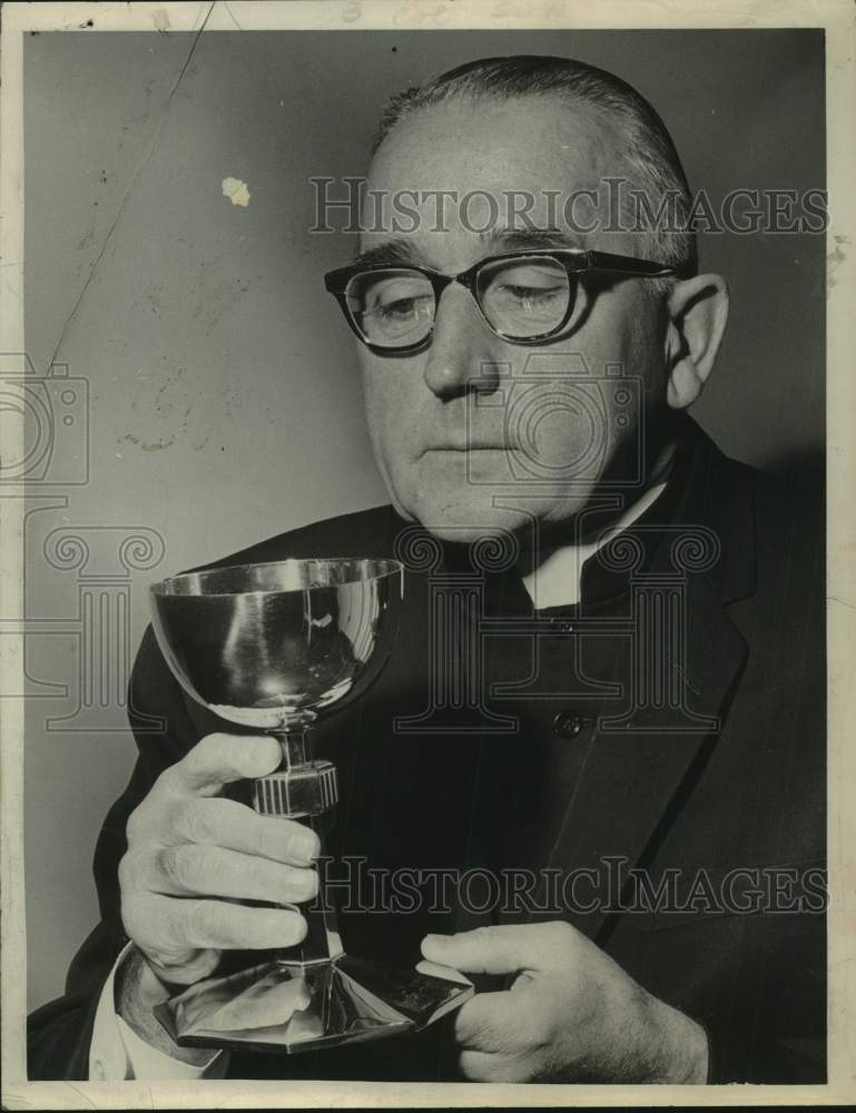 Press Photo  Monsignor Edward O'Malley, holds up a chalice - Historic Images