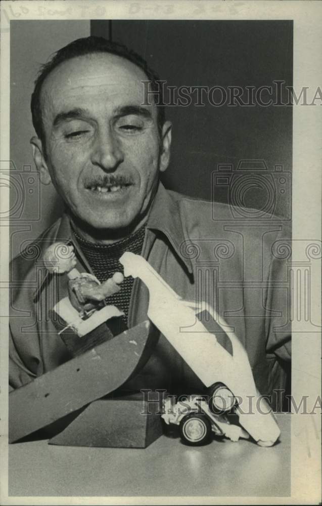 Press Photo Barney Pirofsky Shaw looks at wooden boat and car - Historic Images