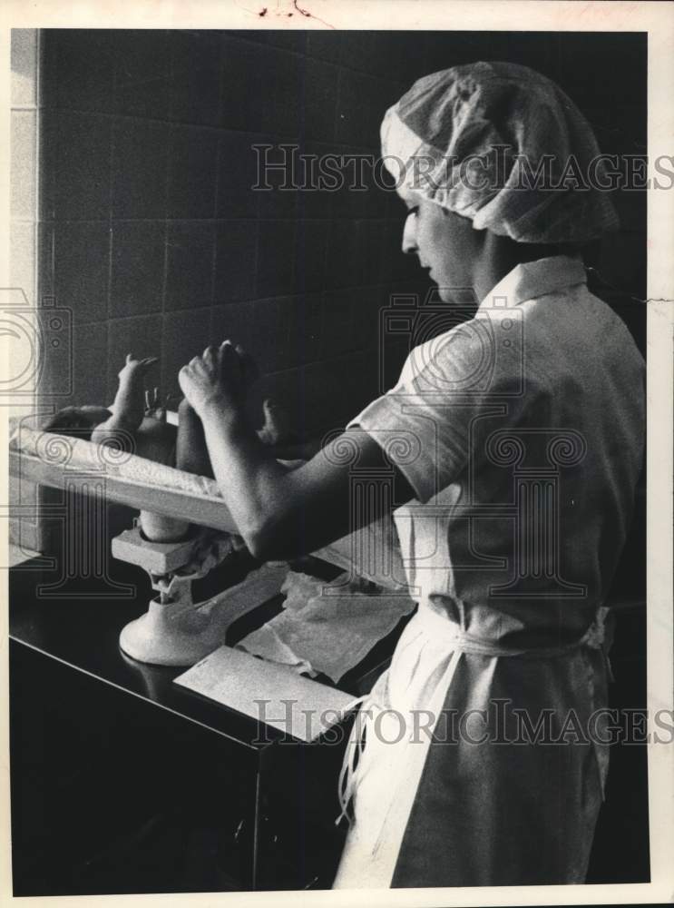 1979 Nurse attends baby at St. Clare's Hospital, Albany, New York - Historic Images