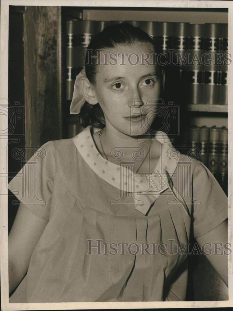1960 Mrs Jesse Lott (Laura Taylor) sits in front of books on shelf - Historic Images