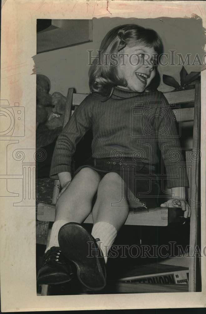 Beth St John smiles while sitting in a chair - Historic Images