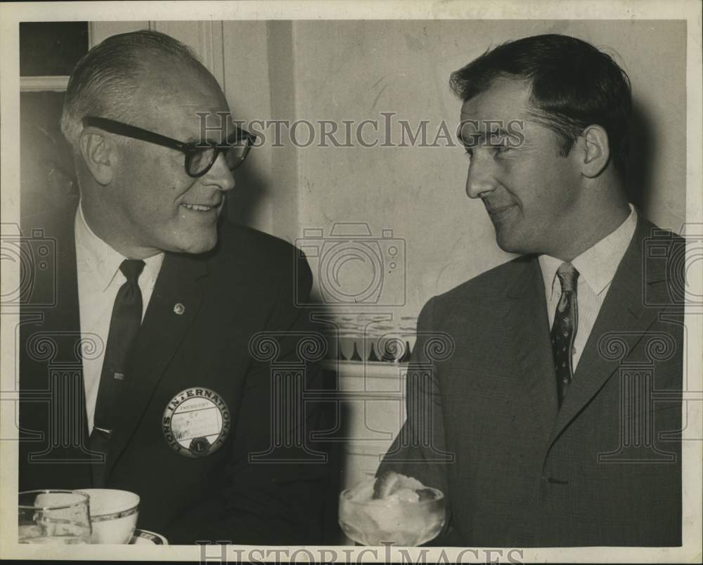 1964 Lion's Club President speaks with Hrvote Lisinski at dinner - Historic Images