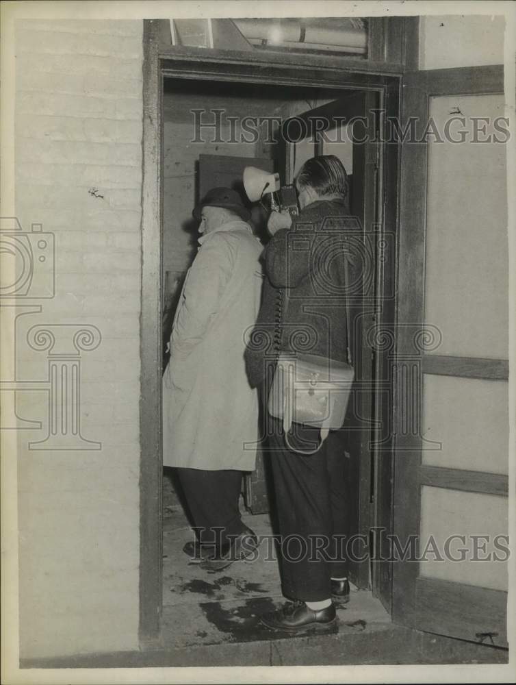 1962 Photographer taking a picture in a New York doorway - Historic Images
