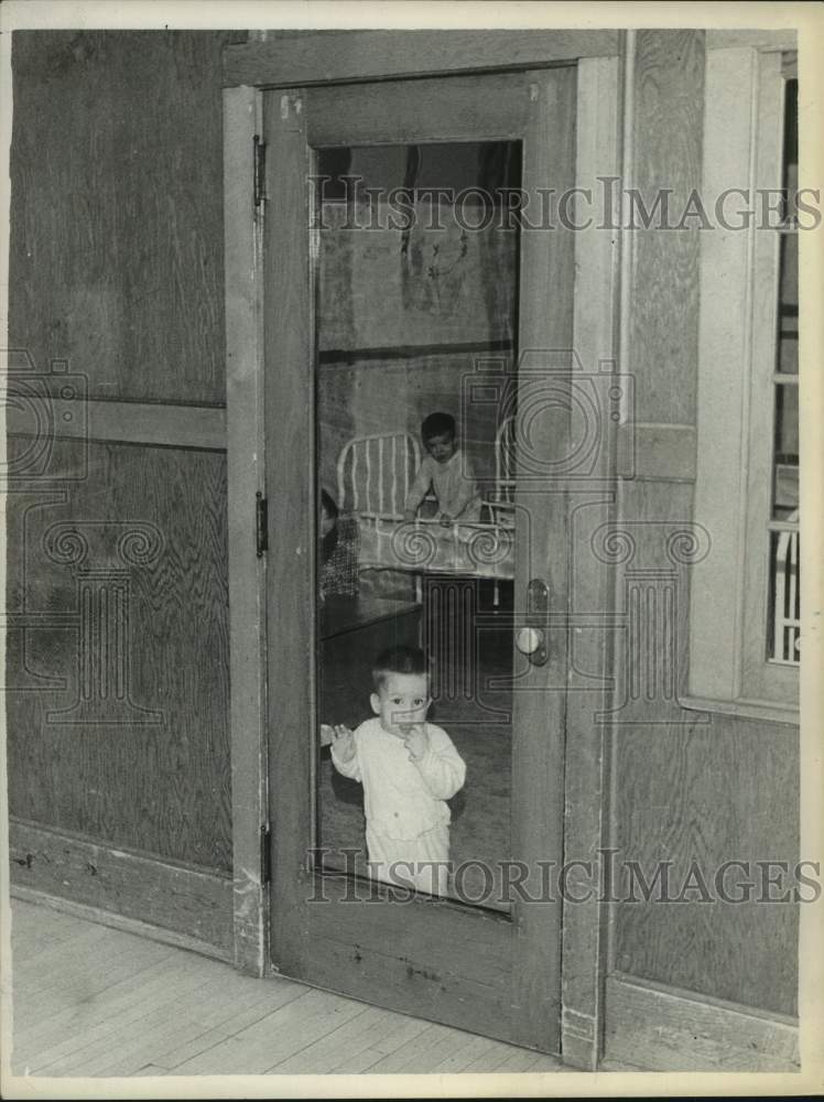 1962 Toddlers visible in door of room at St Catherine Infant home - Historic Images