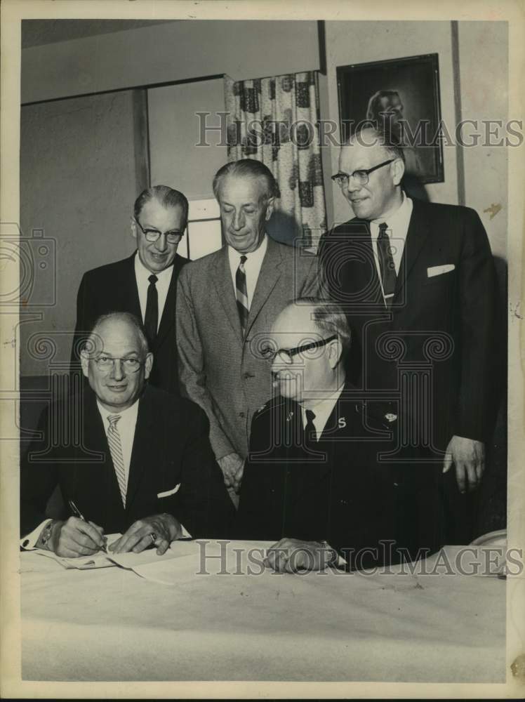 1963 Salvation Army reps sign Community Chest contract in New York - Historic Images