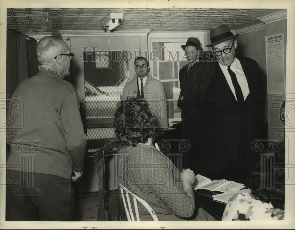 1962 Men in suits speak with elderly couple in New York building - Historic Images