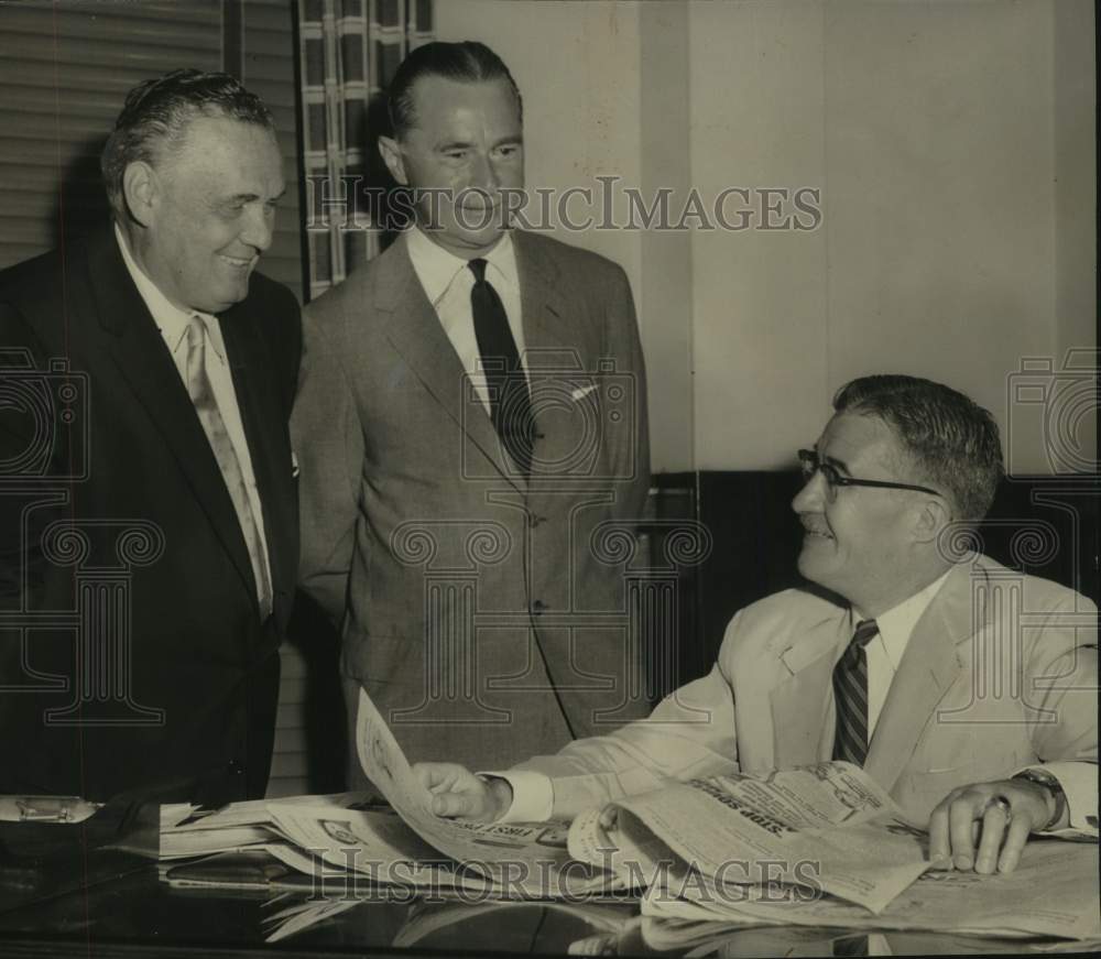 1956 Press Photo Gerald Salisbury, George Frank &amp; Henry Stack look at newspaper - Historic Images