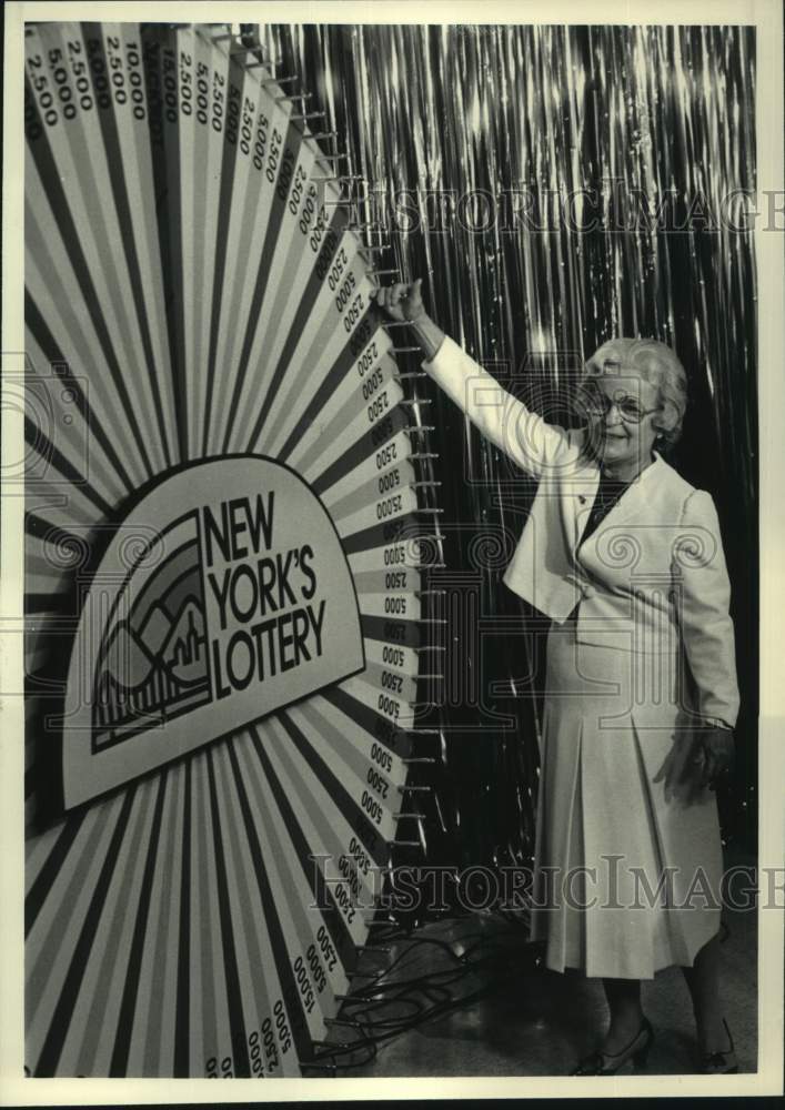 1987 Irene Comtois spins lottery wheel on Channel 10, Albany, NY - Historic Images