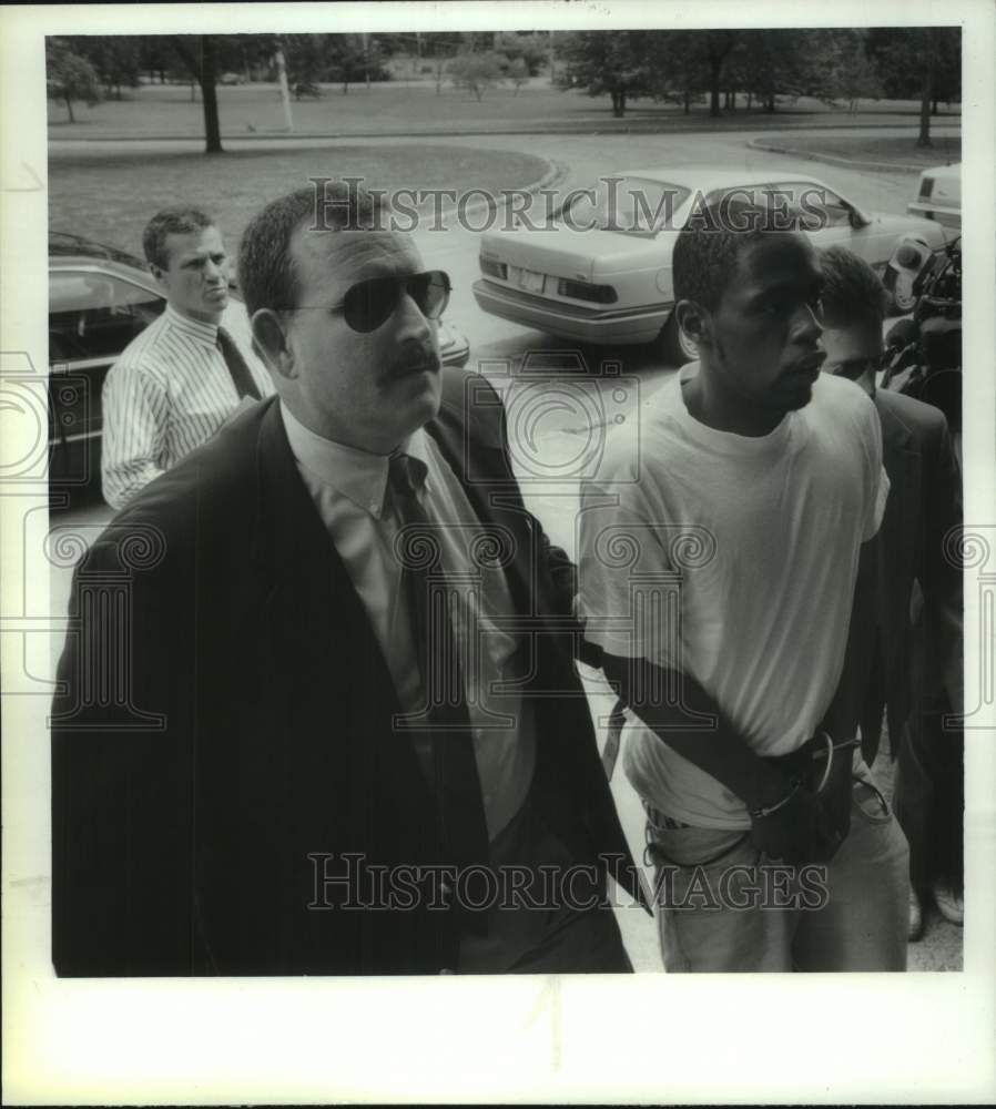 1994 Police lead suspect into Loudonville, New York Police station - Historic Images