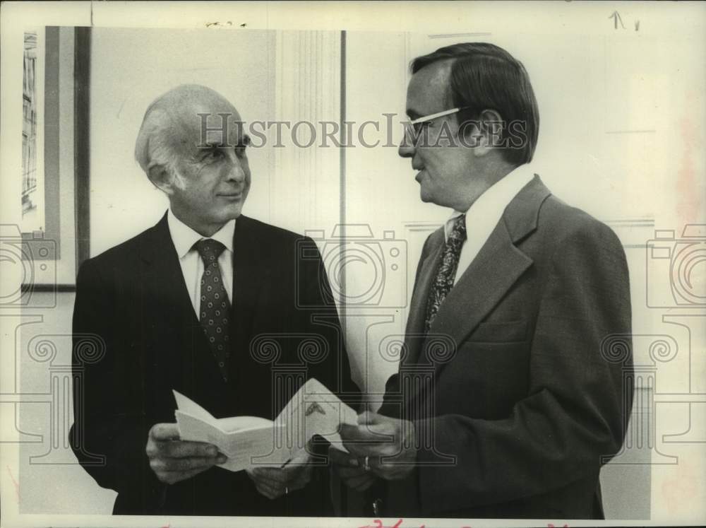 1976 William Walker Gibson and Harold E Santee look over brochure - Historic Images