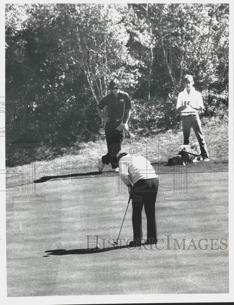 E.J. Cardish watches Bob Haggerty putt during golf round in New York - Historic Images