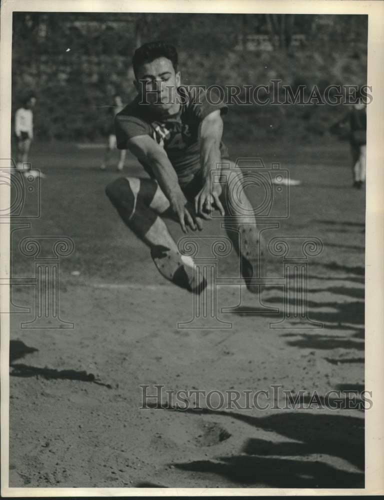 1949 Press Photo Long jumper competes in track meet at Albany, NY high school - Historic Images
