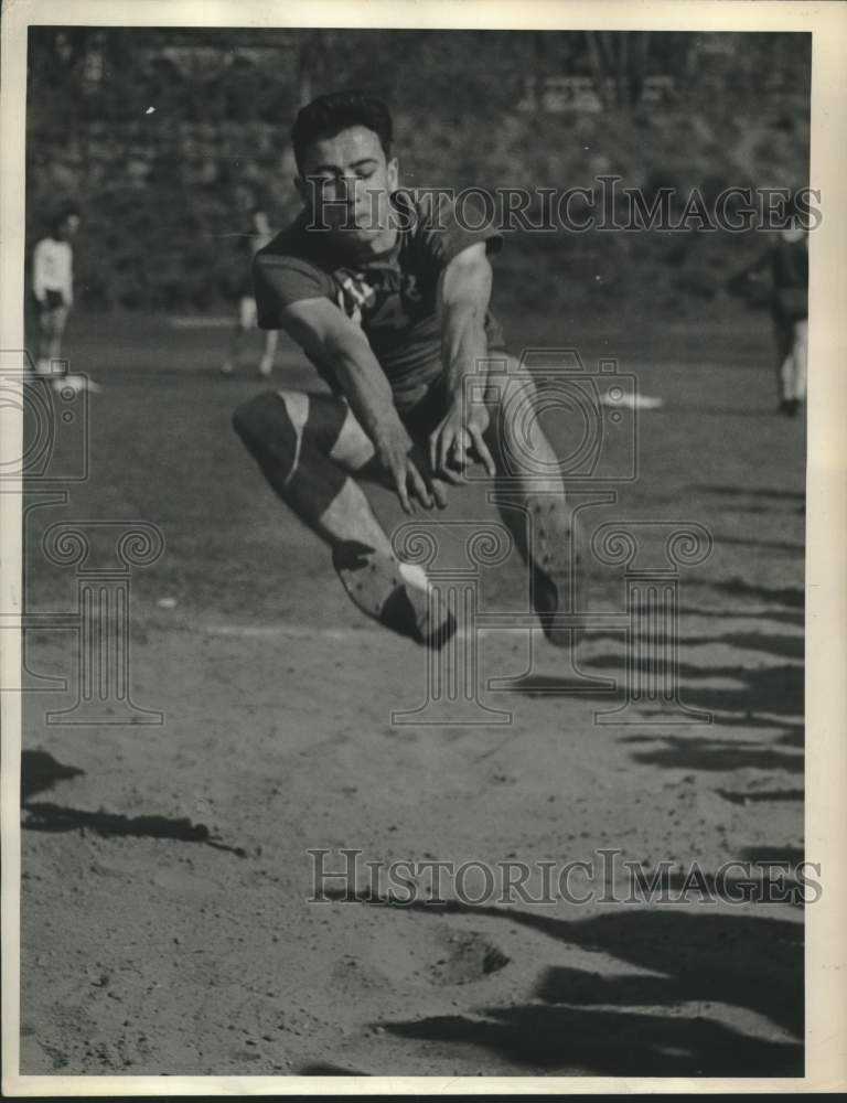 1949 Press Photo Long jumper competes in track meet at Albany, NY high school - Historic Images