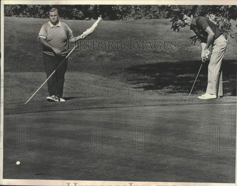 1979 Dave Philo Jr watches putt during round of golf in New York - Historic Images