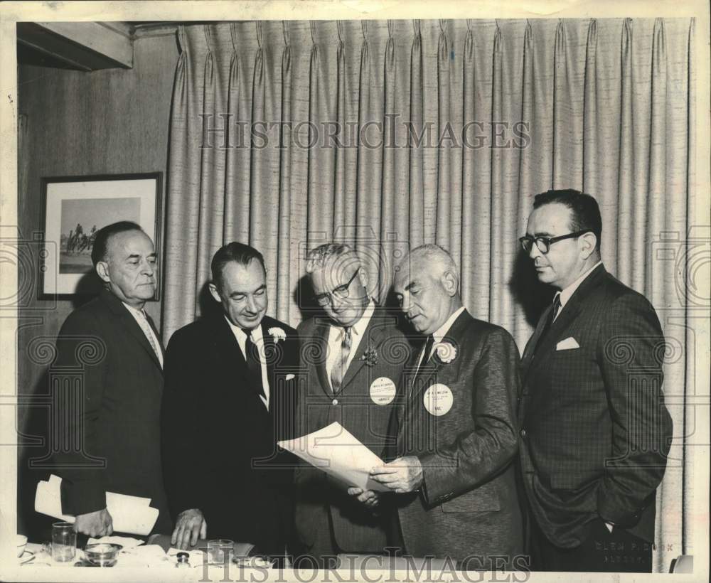 Businessmen look over report in New York conference room - Historic Images