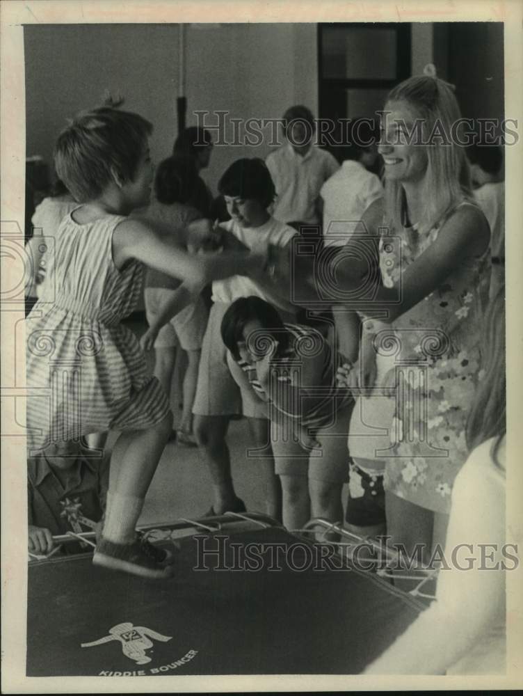 1972 Arlene Flanagas watches Carolyn Freeman on trampoline, New York - Historic Images