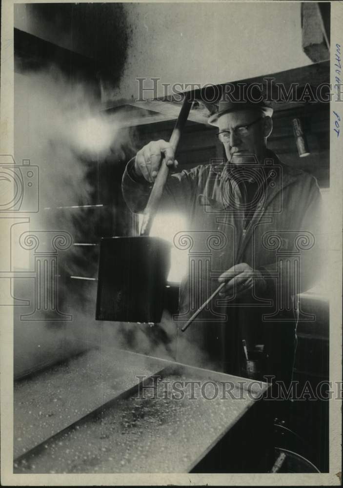 1973 Farmer checks maple syrup process in New York - Historic Images