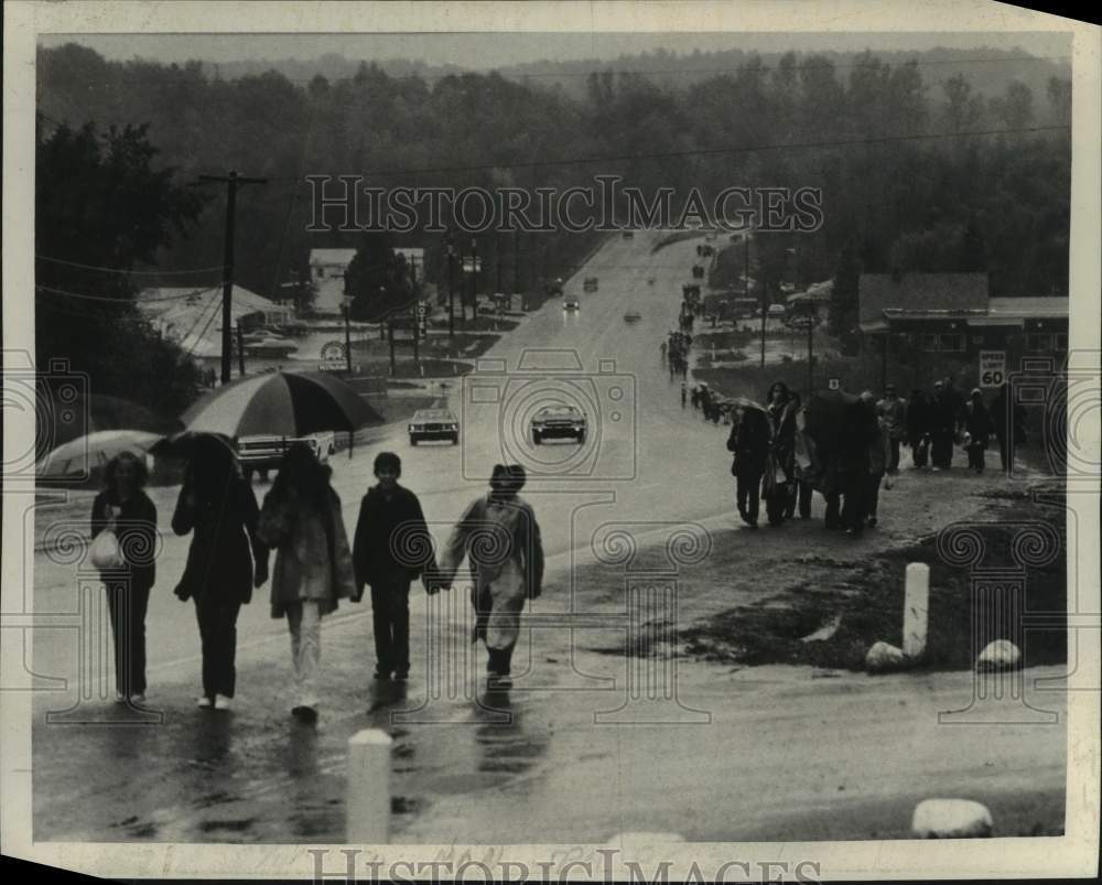 1972 March of Dimes Walkathon participants walk in the rain - Historic Images