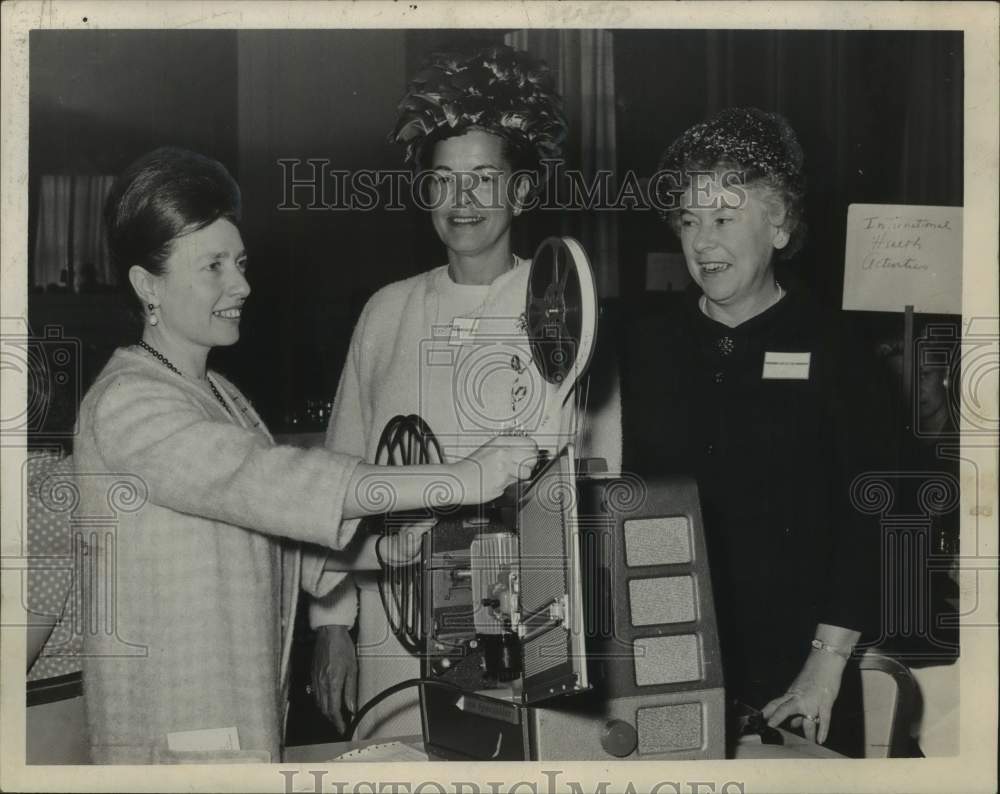 1964 New York State Medical Auxiliary members prepare to show movie - Historic Images