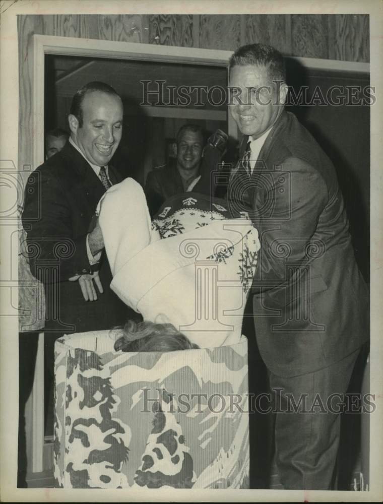 Men help Miss Snowflake take dive in barrel in New York - Historic Images