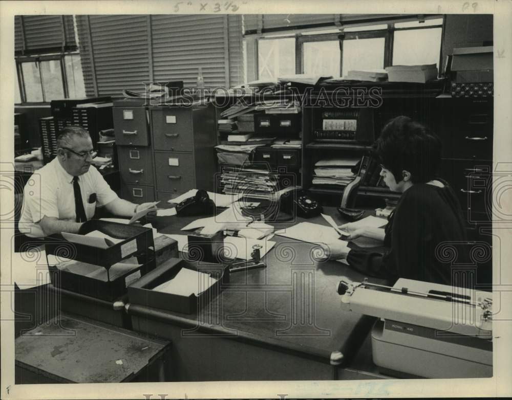1969 Richard Lynn & Claire Dunyeir sit at their desks in Credit Dept - Historic Images