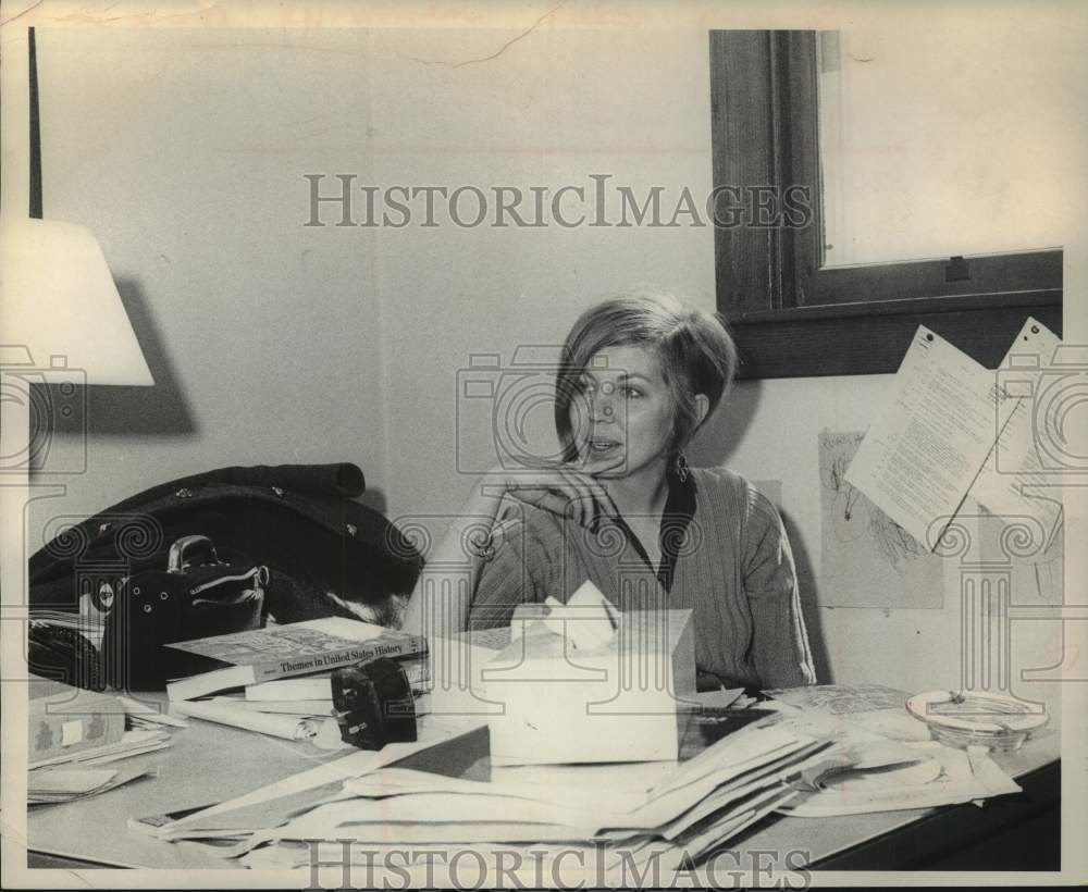 Press Photo Mary Lynn, instructor in History, sits behind her desk - Historic Images