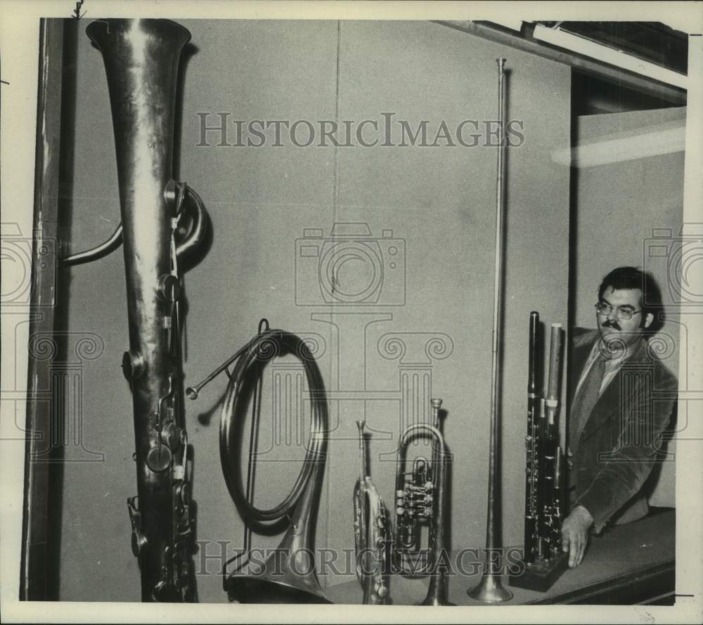 1974 Douglas B Moore, curator, assembles musical instruments - Historic Images