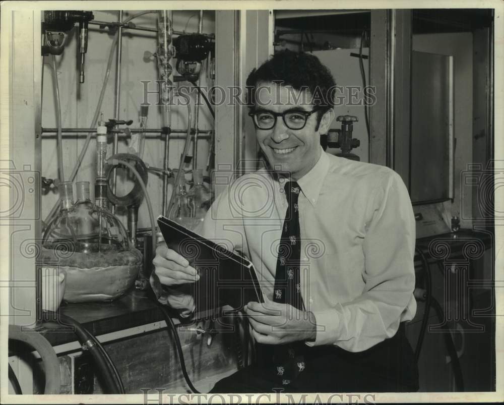 1972 Dr Mark Markautz stands next to large steam turbine equipment-Historic Images