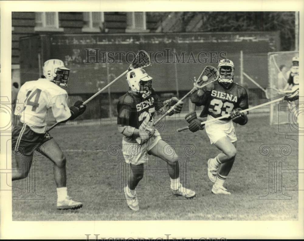 Siena College (New York)  Lacrosse Players run with ball in match - Historic Images