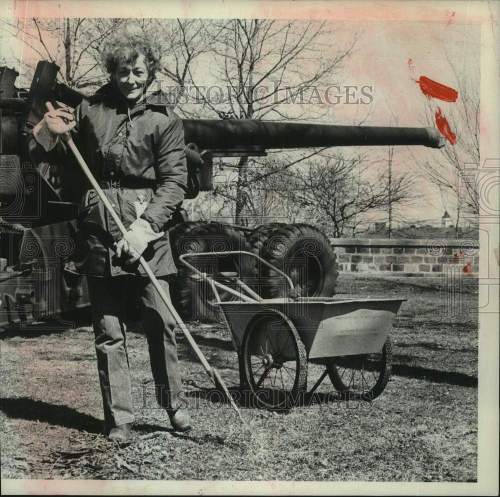 1975 Press Photo Madeline Richards rakes area around cannon in New York - Historic Images