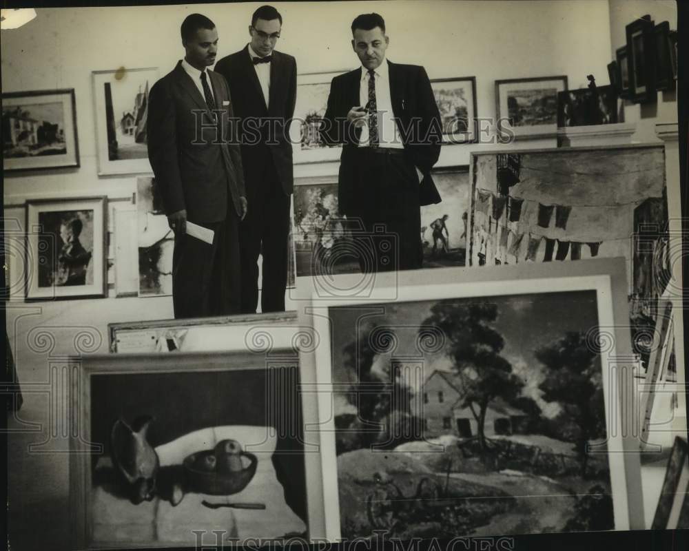 1962 Judges examine art show entries in Albany, New York - Historic Images