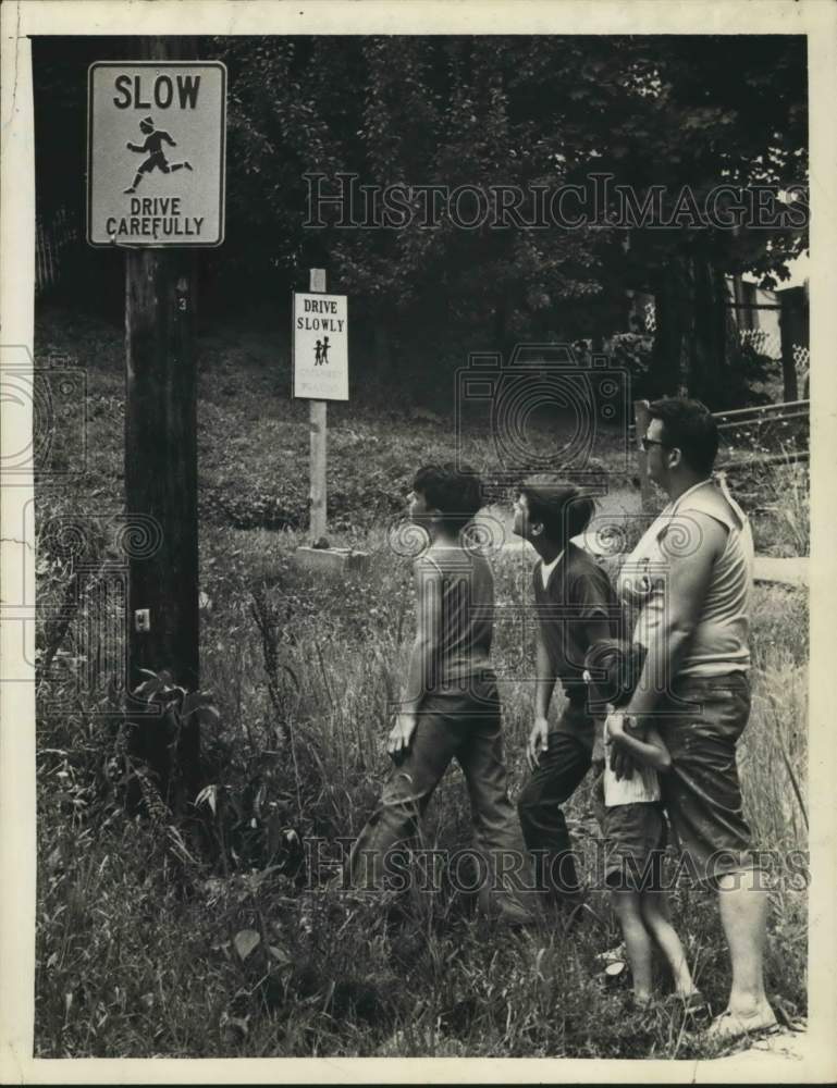 1977 Family inspects traffic caution sign in Rensselaer, New York - Historic Images