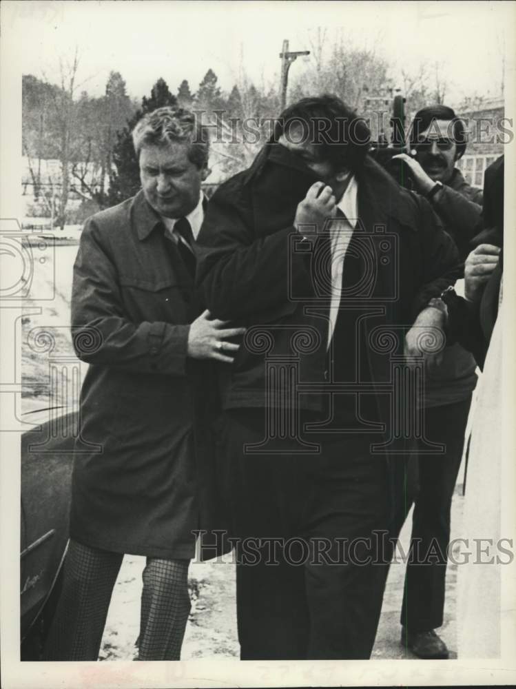1978 Arrested man hides his face in Loudonville, New York - Historic Images
