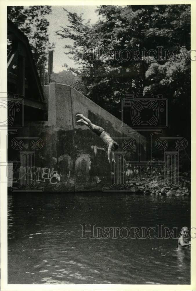 1990 Press Photo Steve Keller dives into Kinderhook Creek from bridge, New York- Historic Images