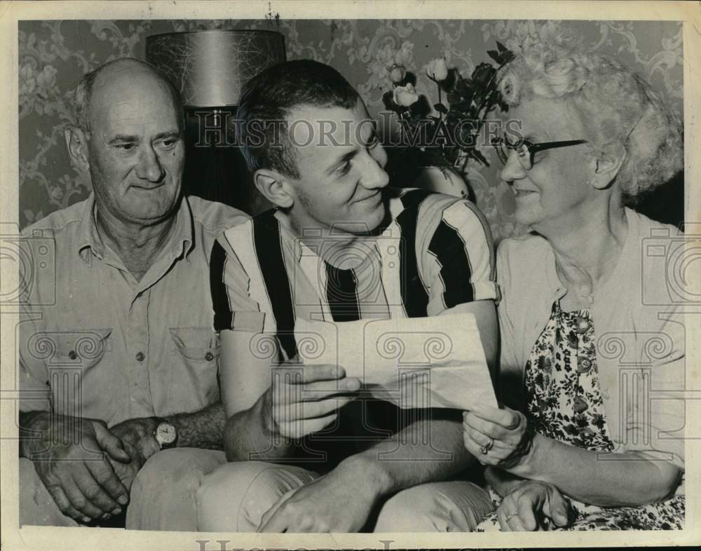 1961 John Kilbars looks over paper with couple in New York home-Historic Images