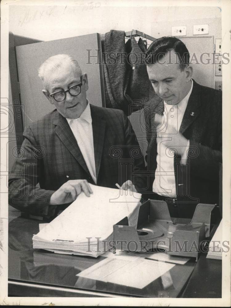 1964 Frederick A. Allison & colleague look over report in New York-Historic Images